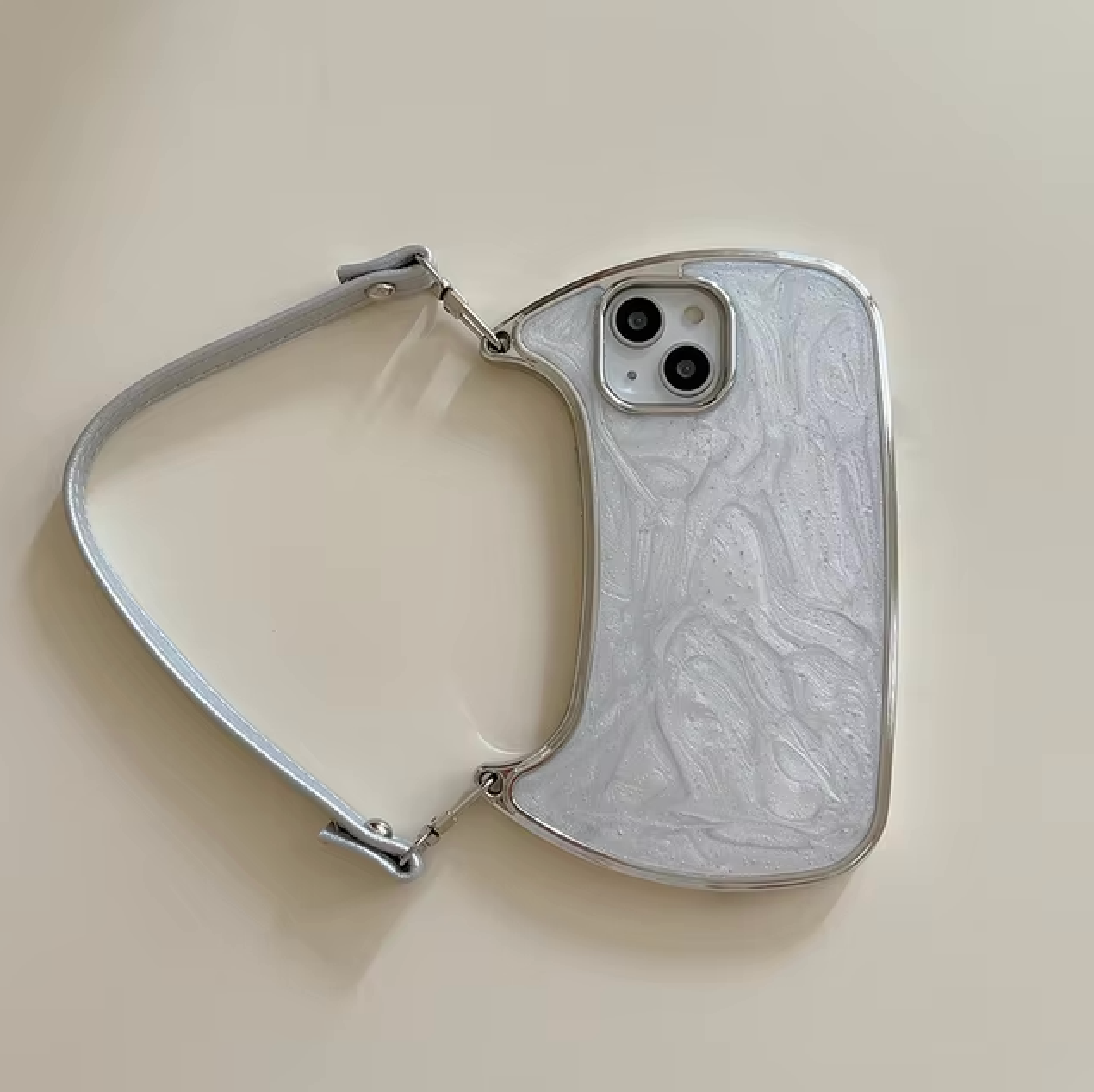 The Electroplated Handbag Hand Strap Phone Case by curved cases showcases a white abstract-shaped design, complete with a built-in slot for an iPhone case compatible with models ranging from the iPhone 7 to the iPhone 15. The handbag features dual camera accommodations, a short strap for easy carrying, and glitter metallic waves on its textured surface.